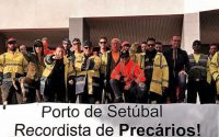 Dockers of the port of Setúbal displaying banner against precarious work in the port.